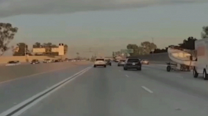 Boat FLIES Across California Freeway After Detaching