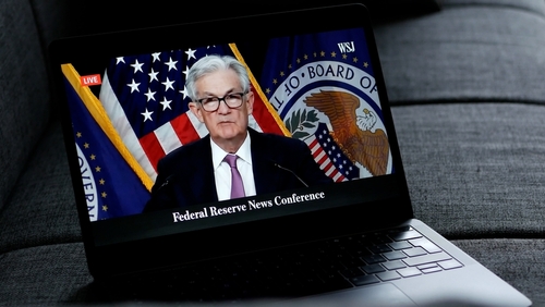 Federal Reserve Chairman speaking at a news conference, televised.
