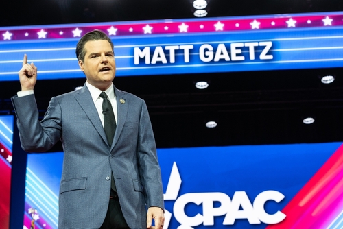Matt Gaetz speaking at CPAC in front of sign.
