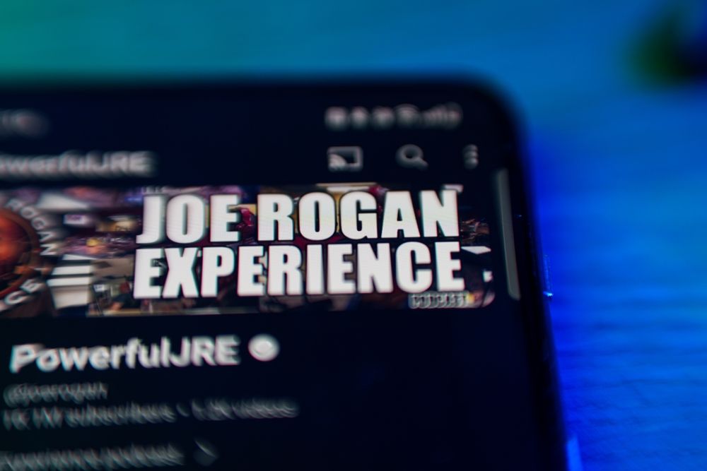 Smartphone screen with Joe Rogan Experience logo visible