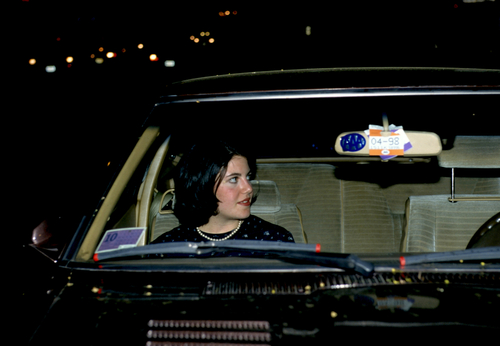 A woman in a car at night.
