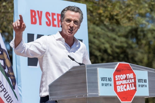 Gavin Newsom speaking at a podium, 