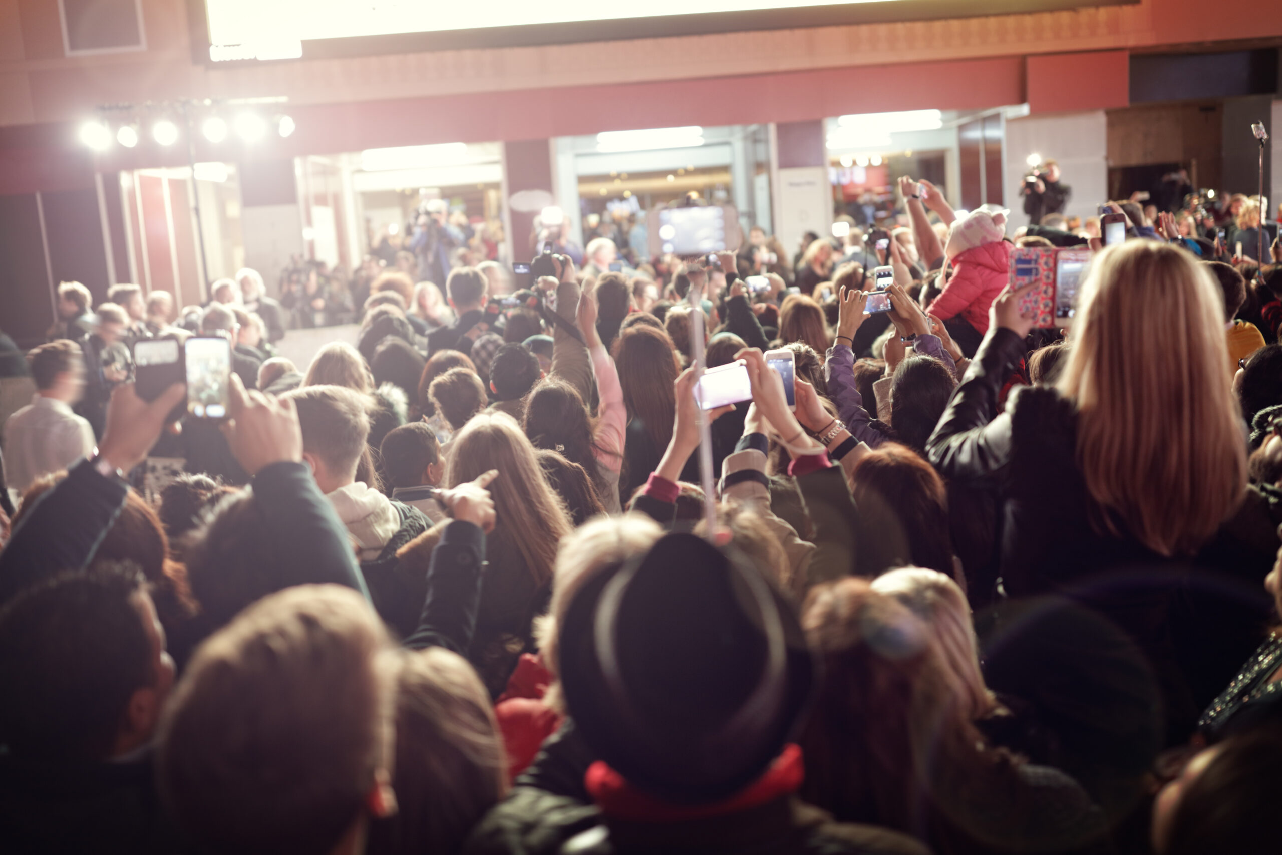 Crowd with phones at an event indoors