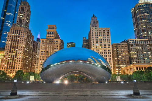 The Bean sculpture in Chicago cityscape at dusk.