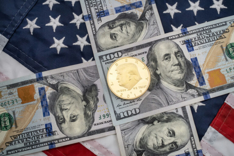 American flag background with hundred dollar bills and coin