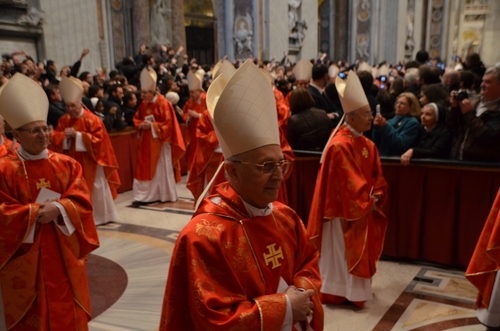 Cardinals in red robes and mitres participating in a religious ceremony