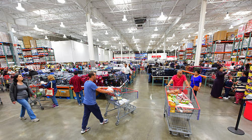 Busy warehouse store with customers shopping and pushing carts