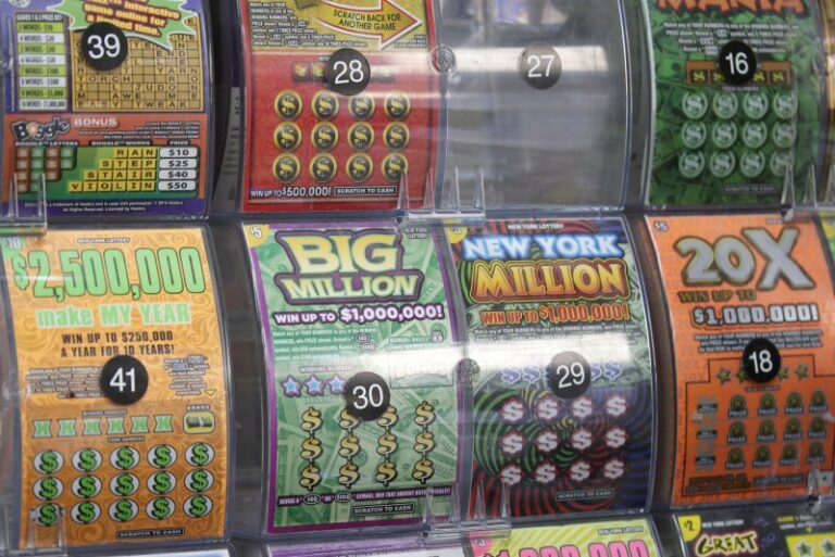 A display of various colorful lottery scratch-off tickets with different prize amounts